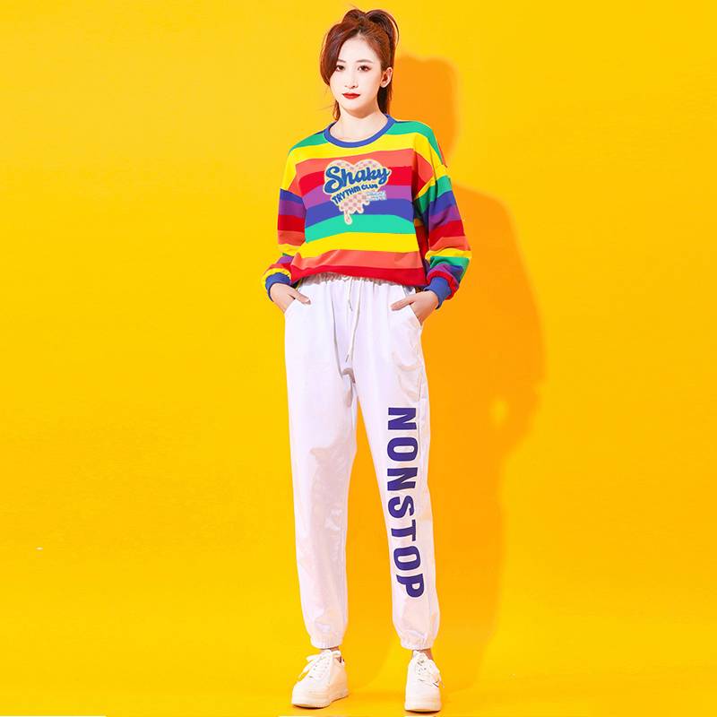 One woman, long sleeve, long shirt, white pants